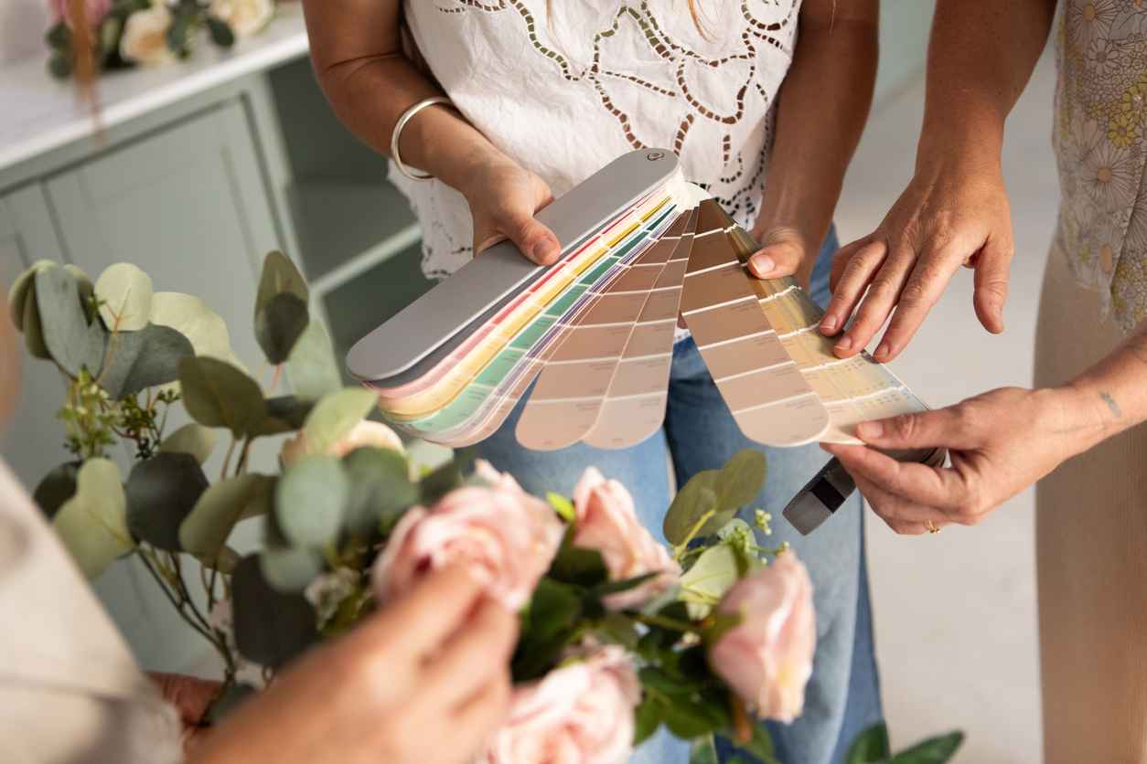 Two women reviewing color palettes to match with bouquet