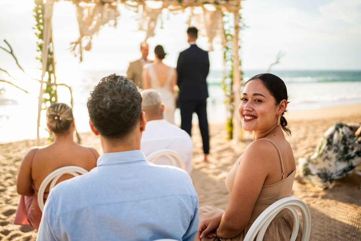 Portrait of a young wedding guest woman in a wedding ceremony on the beach