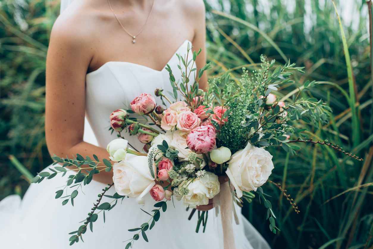 Bride holding a rustic wedding bouquet