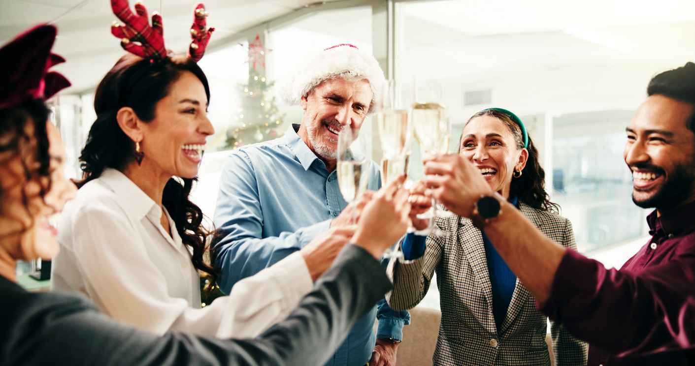Business people, champagne toast and Christmas at office, celebration and festive event with smile at company.